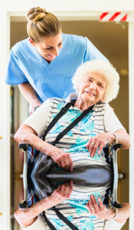 elder in a wheelchair with her caregiver